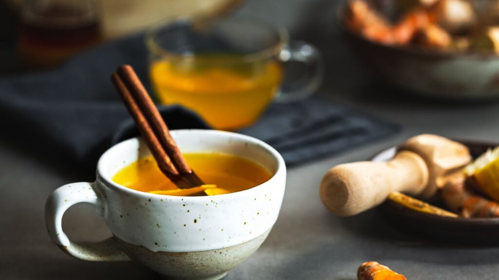 turmeric tea with ginger and cinnamon leaves